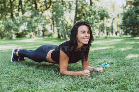 Young Happy Fit Tanned Brunette Goes In For Sports Dressed In Active Black Clothes Does