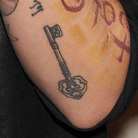 The standing stone is placed artistically has placed artistically in the midst of a rose bush. Ruby Rose's 19 Tattoos & Meanings | Steal Her Style