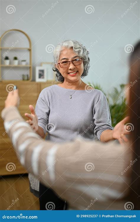 Happy Mature Mother Opening Her Arm To Hug Her Adult Daughter Happy Family Concept Stock Image