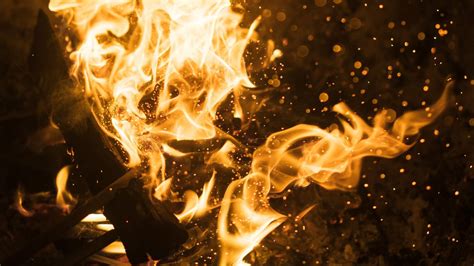 Download Wallpaper 1366x768 Bonfire Fire Flame Sparks Glare Tablet