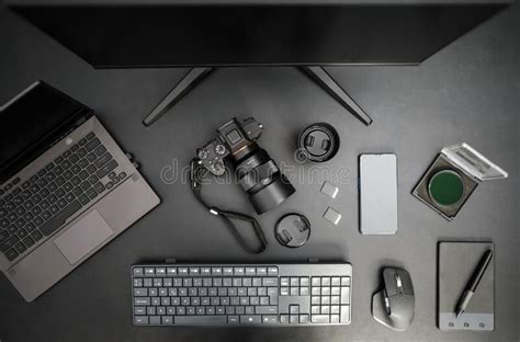 Top View Of Photographer Workplace With Camera Computer Lens Mobile