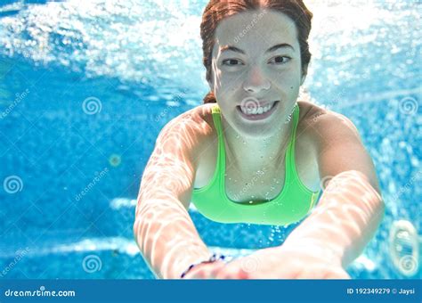 Child Swims Underwater In Swimming Pool Happy Active Teenager Girl