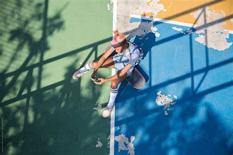 Modern Girl Sitting On Her Skateboard By Jovo Jovanovic