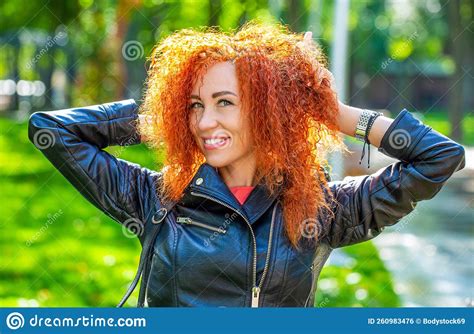 Portrait Of Beautiful Cheerful Redhead Girl Flying Curly Hair Smiling