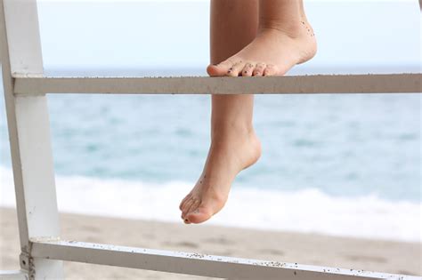 Young Womans Barefeet Climb Ladder Above Beach Stock Photo Download