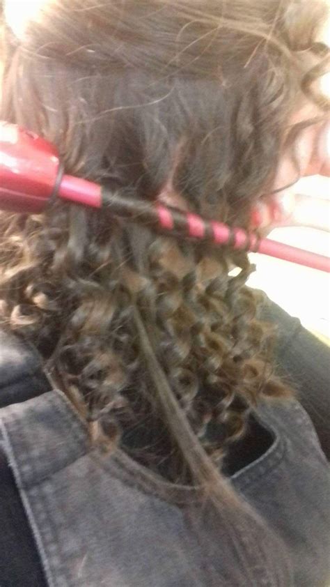 Tight Ringlet Curls Are Being Created Here By Using A Very Small
