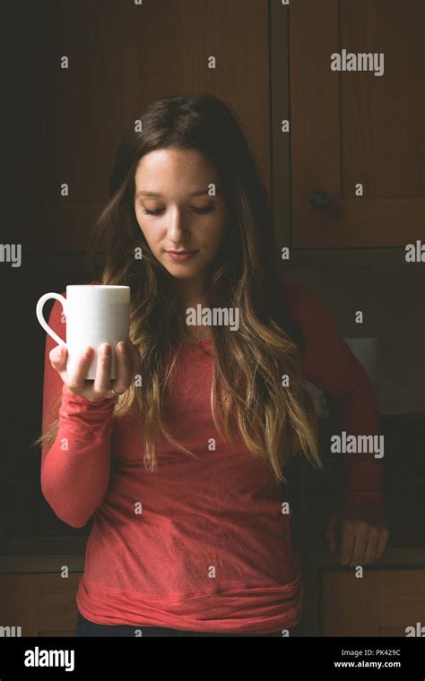 Woman Having Coffee Mug In Kitchen Stock Photo Alamy