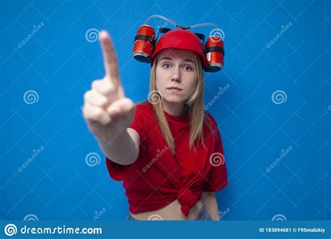 Girl Fan Shows Finger Number One On A Blue Background Cheerleader In Uniform Stock Image