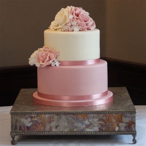 two tier wedding cake with pink and ivory sugar roses