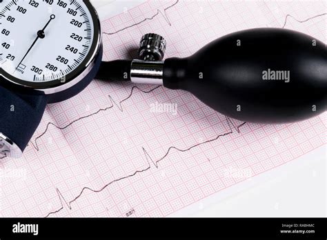 A Blood Pressure Manometer On A Cardiogram Ecg Aneroid