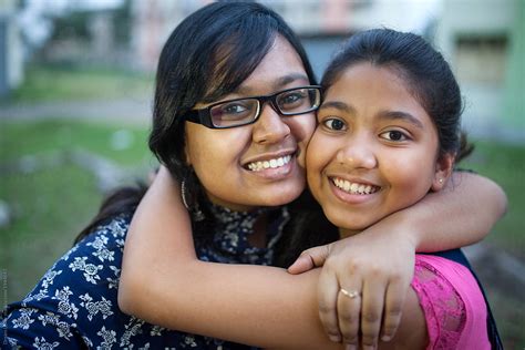 Two Sisters Sharing Happy Moments And Making Fun At Outdoors Del