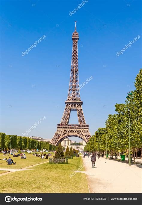Eiffel Tower In Paris With Grass Lawn And People Paris France