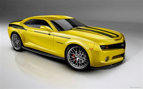 This small yellow car is photographed parked in front of a run down wall. 2010 Camero Yellow Wallpaper | HD Car Wallpapers | ID #426