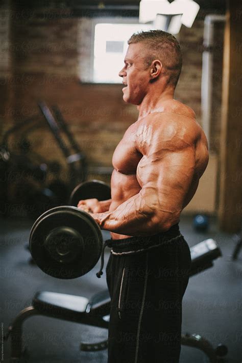 Male Bodybuilder Lifting Weights In Gym By Stocksy Contributor Jess