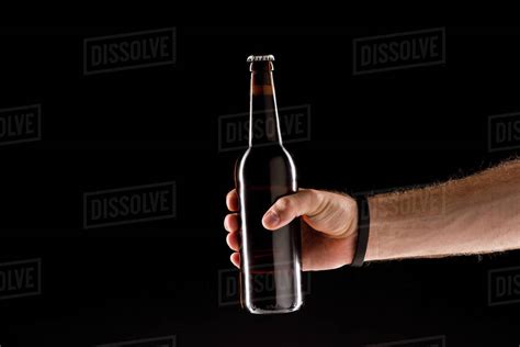 Cropped Image Of Man Holding Beer Bottle Isolated On Black Background
