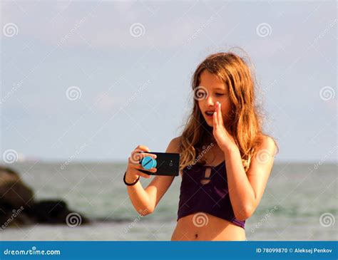 La Ragazza Fa Un Selfie Sulla Spiaggia Del Mare Fotografia Stock