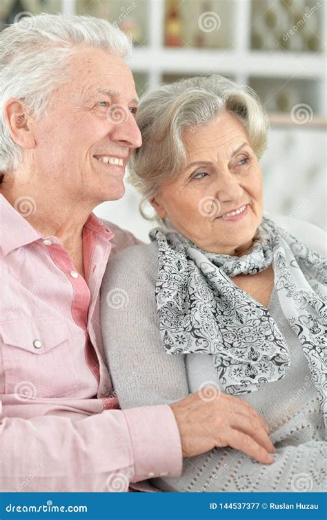 Happy Beautiful Senior Couple Sitting On Couch At Home Stock Image Image Of Male Senior
