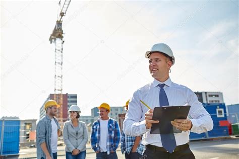 Happy Builders And Architect At Construction Site — Stock Photo © Syda