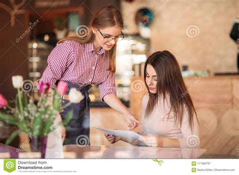 Hospitable Waitress Help To Customer What To Choose Stock Image - Image of looking, hospitality ...