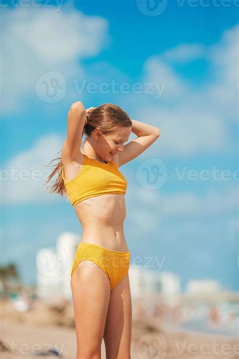 Adorable Slim Teen Girl In Yellow Swimsuit On The Beach Stock Photo At Vecteezy