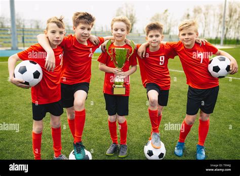 Happy Young Boys In Football Team Kids In School Soccer Sports Team