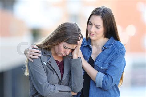 Worried Woman Comforting Her Sad Friend In The Street Stock Image