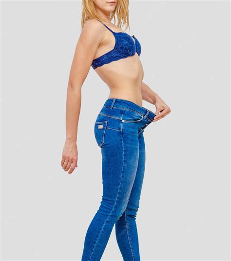 Premium Photo Woman Shows Weight Loss In Old Big Jeans