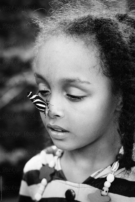 Girl With A Striped Butterfly Sitting On Her Nose Del Colaborador De Stocksy Anya Brewley