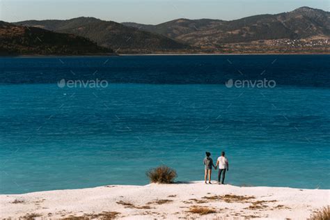 A Couple In Love Looks At The Blue Lagoon Couple In Love On The Beach