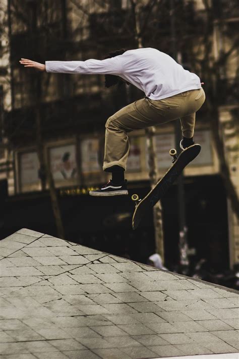 A Man Flying Through The Air While Riding A Skateboard
