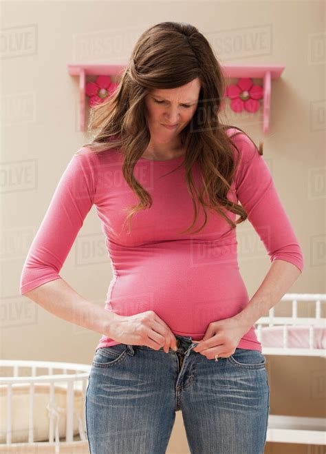 Usa Utah Lehi Young Pregnant Woman Buttoning Jeans Stock Photo