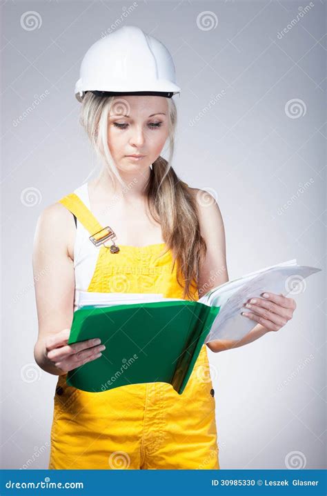 Young Architect Woman Construction Worker Reading Blueprints Stock