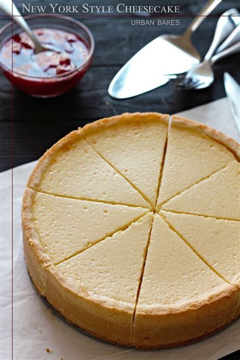 A Cheesecake Sitting On Top Of A Piece Of Paper Next To A Knife And Fork