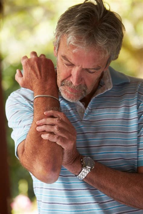 Mature Man Suffering From Painful Elbow At Home Stock Photo Image Of