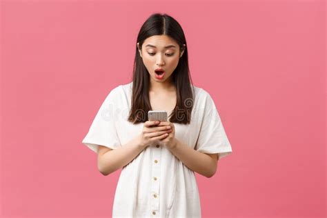 Beauty People Emotions And Technology Concept Shocked And Startled Asian Girl Reading Big News