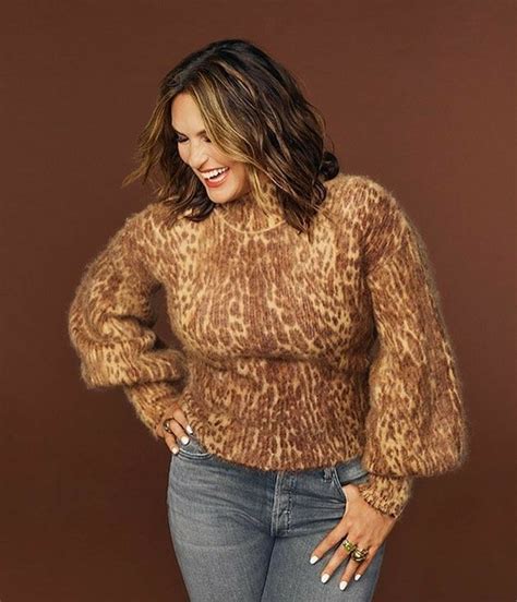 A Woman Wearing Jeans And A Leopard Print Sweater