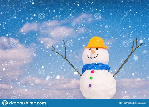 Cute Smiling Snowman Against Blue Sky Background With Falling