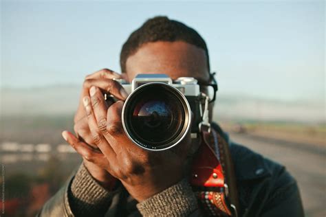 Portrait Of A Man Taking Photos With A Vintage Film Camera By Stocksy
