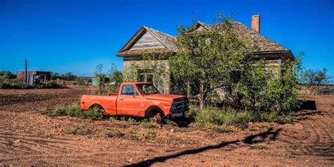 Abandoned Farm House And Gmc Truck Sitting On Blocks In Anson Texas