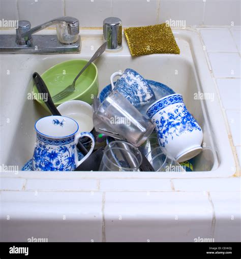 Load Of Dirty Dishes In Kitchen Sink Stock Photo Alamy