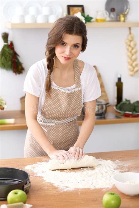 Young Brunette Woman Cooking Pizza Or Handmade Pasta In The Kitchen