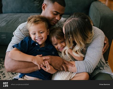 Parents Hugging And Kissing Their Children Stock Photo Offset