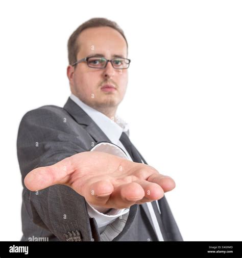Business Man Reaches Out His Arm Holding His Hand Directly Into The Camera Isolated On White
