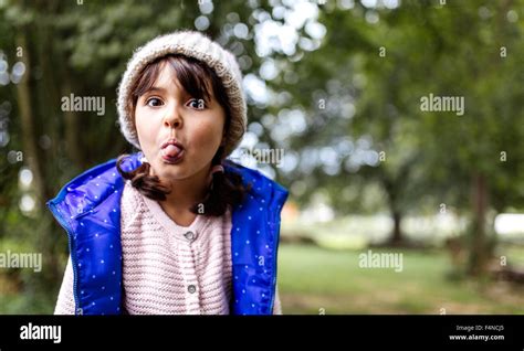 Portrait Of Little Girl Sticking Out Her Tongue Stock Photo Royalty