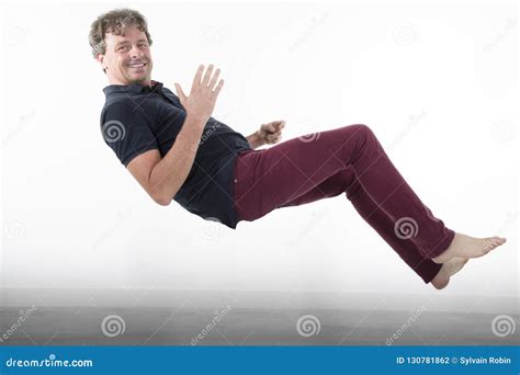 Man In Levitation Falling Floating Up At Home In House White Wall Stock