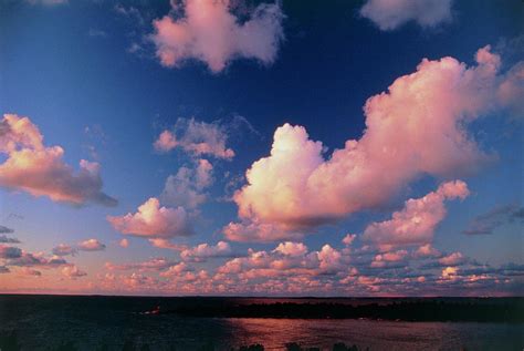 Fair Weather Cumulus Clouds Over Water At Sunset Photograph By Pekka