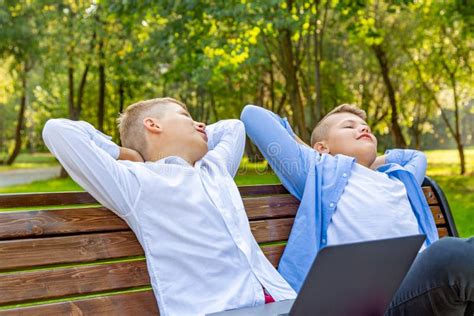 Teenage Boys On Park Bench Have Fun And Relax Stock Photo Image Of