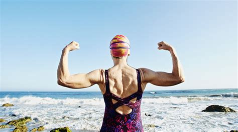 Older Caucasian Woman Flexing Her Muscles On Beach Ptsr Hastings