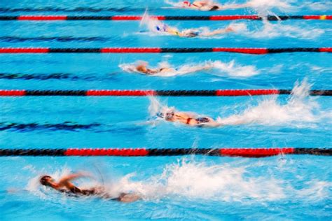 Swimmers Using A Powerful Flutter Kick In A Freestyle Swimming Race