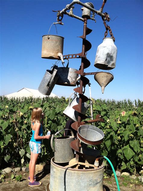 Galvanized Water Cans And Old Repurposed Farm Junk Made Into A Fountain
